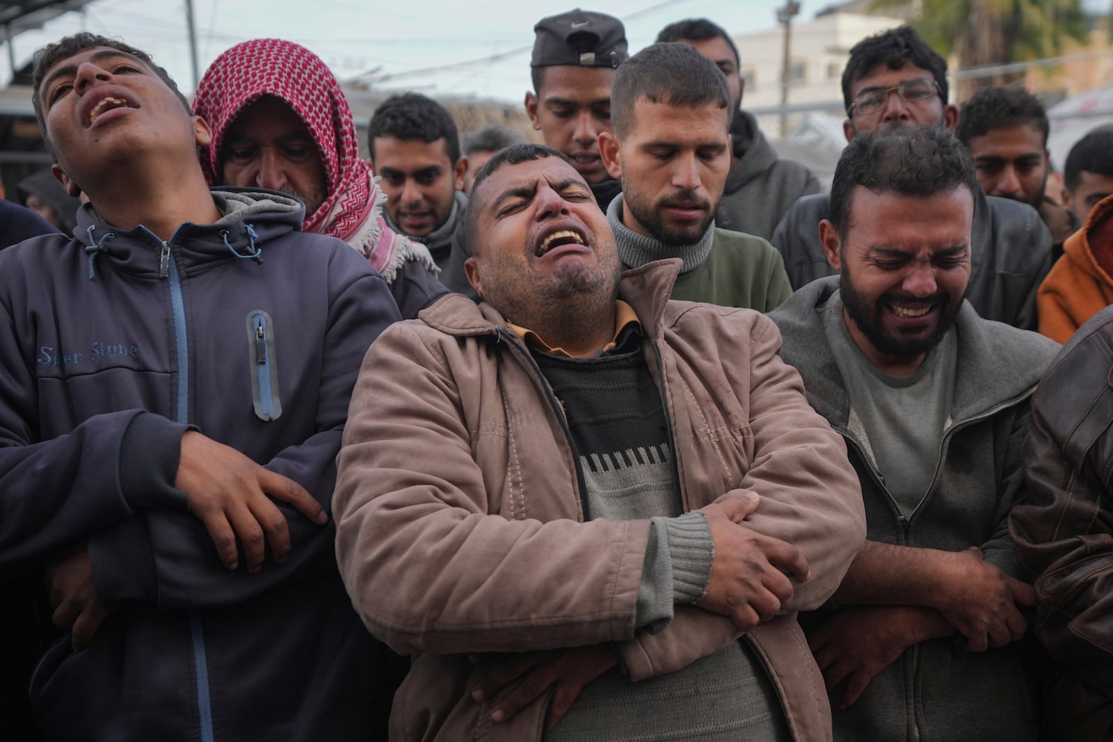 Palestinians mourn their relatives killed in the Israeli bombardment of the Gaza Strip, at Al-Aqsa Martyrs Hospital in Deir al-Balah, Sunday, Jan. 5, 2025. (AP Photo/Abdel Kareem Hana)