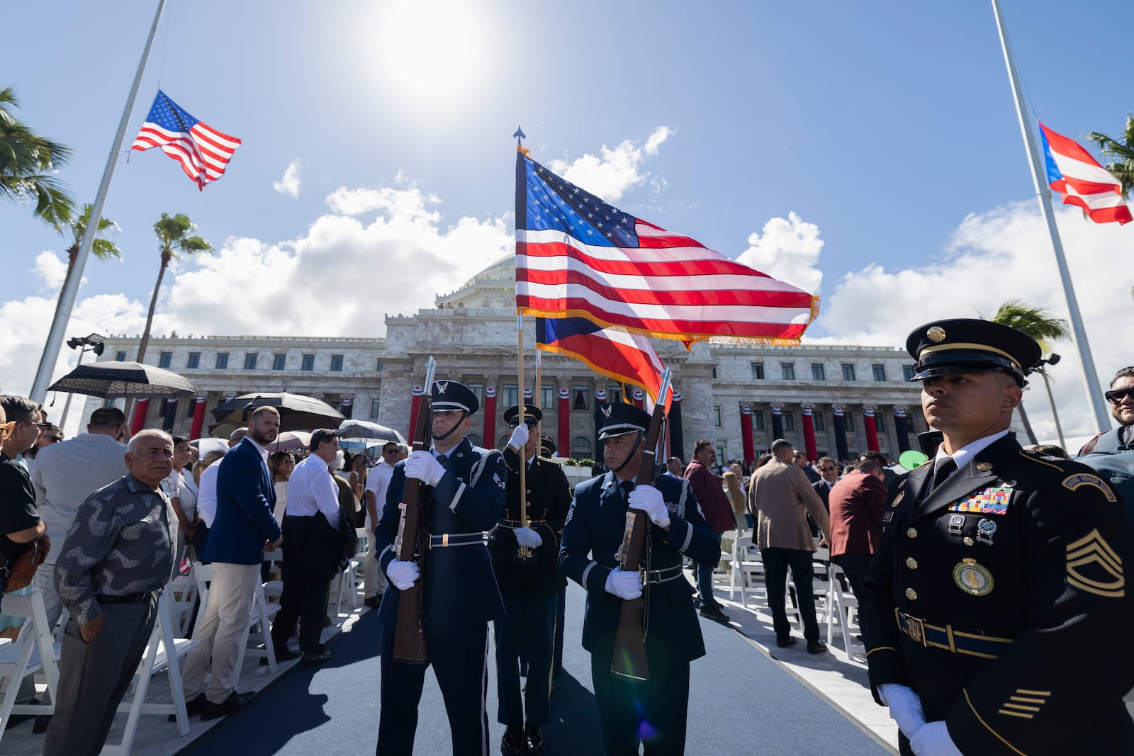 Soldiers carry U.S. and Puerto Rico flags during the inauguration ceremony of Jenniffer Gonzalez Colon as the new governor of Puerto Rico at the Capitol in San Juan, Thursday, Jan. 2, 2025. (AP Photo/Alejandro Granadillo)