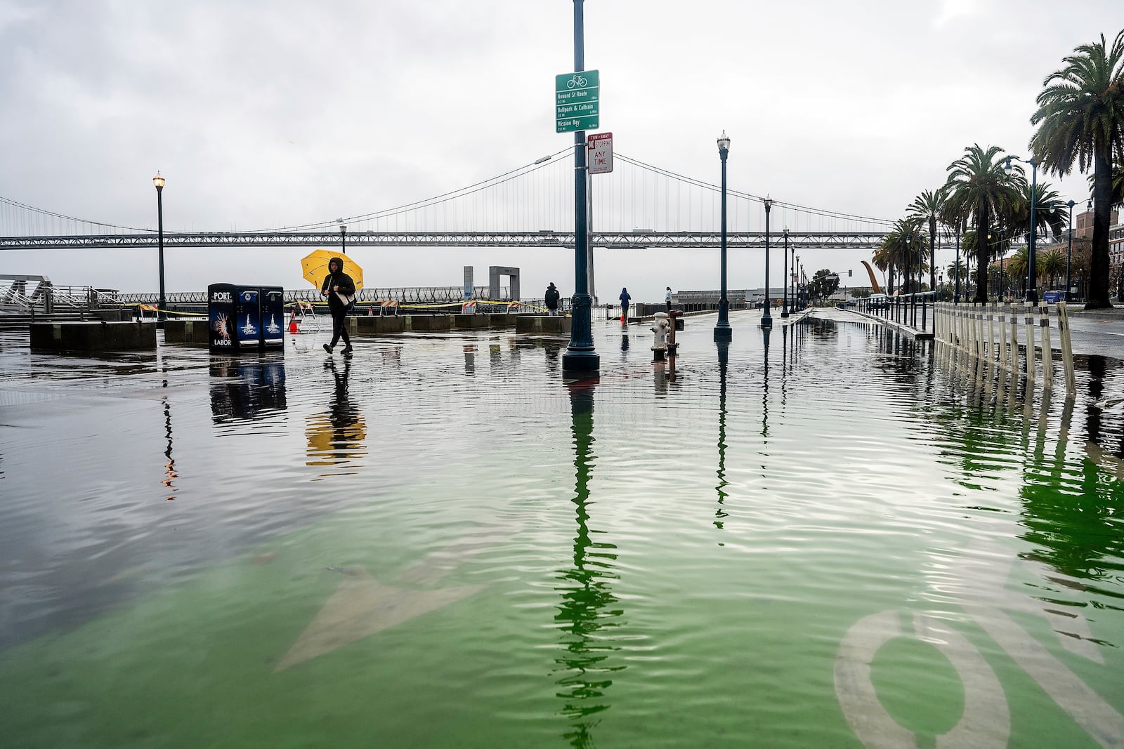 FILE - Water from the San Francisco Bay spills onto the Embarcadero as a result of high tides and storm-driven waves Dec. 14, 2024, in San Francisco. (AP Photo/Noah Berger, File)