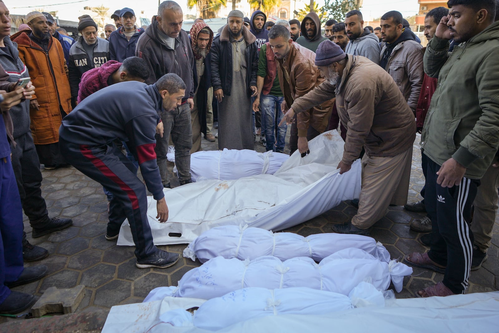 The bodies of victims from overnight Israeli army strikes at multiple locations in the central Gaza Strip are laid together for funeral prayers, at Al-Aqsa Martyrs Hospital in Deir al-Balah, Friday, Jan. 3, 2025. According to Al-Aqsa Martyrs Hospital, 30 people, including 10 women and 7 children, were killed in several attacks overnight in central Gaza. (AP Photo/Abdel Kareem Hana)