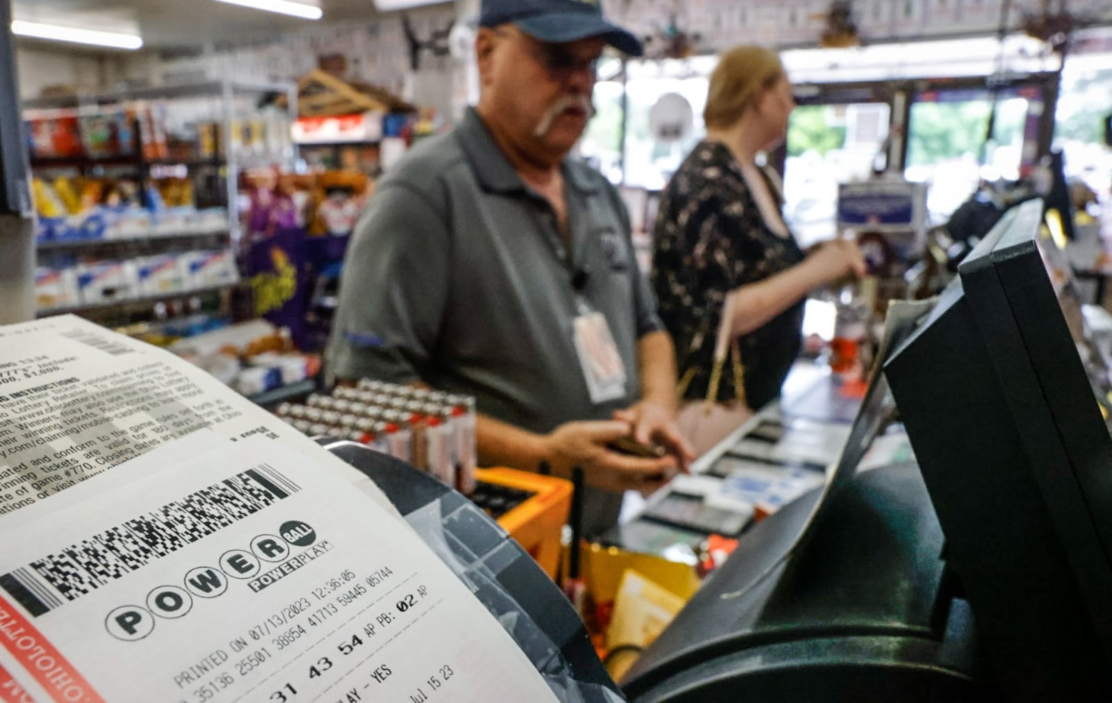 Business was brisk Thursday July 13, 2023 at Bee-Gee's Mini Market on Bigger Road in Kettering because the Powerball has soared to an estimated $875 million ahead of Saturday's drawing. JIM NOELKER/STAFF