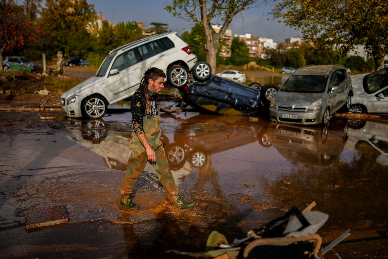 Flooded cars are piled up in Utiel, Spain, Wednesday, Oct. 30, 2024. (AP Photo/Manu Fernandez)