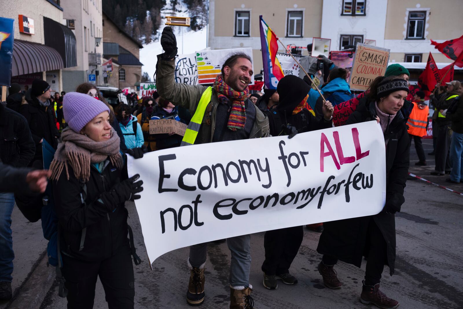 Demonstrators arrive for a protest ahead of the World Economy Forum in Davos, Switzerland, Sunday, Jan. 19, 2025. (AP Photo/Markus Schreiber)