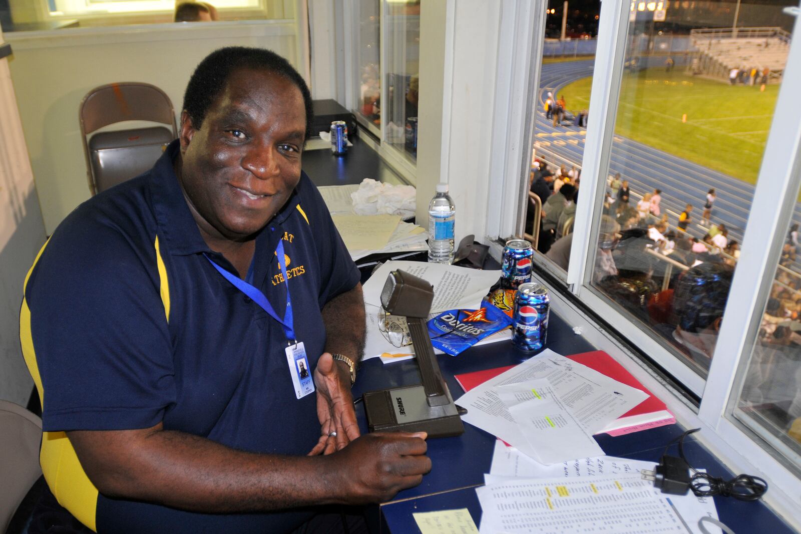 Michael Cooper Sr. is pictured at the microphone during a South High School football game in 2008 at Evans Stadium in Springfield. Staff photo by Bill Lackey