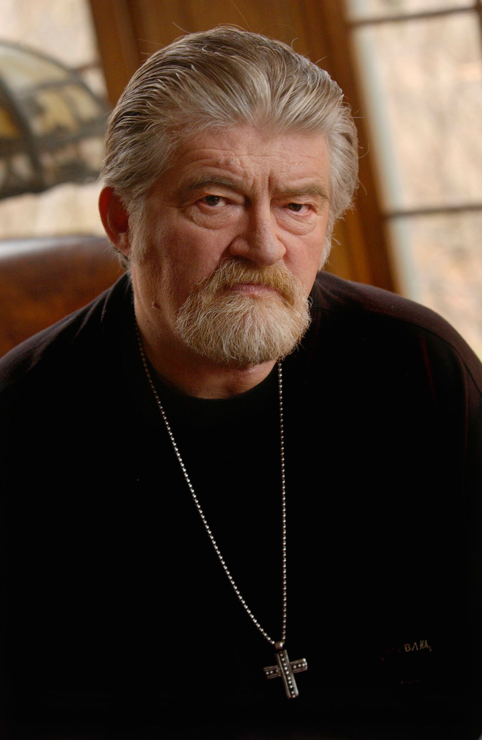 Screenwriter Joe Eszterhas poses for a portrait in his home in Bainbridge, Ohio Monday, Nov. 17, 2003. Eszterhas, who lost part of his larynx to cancer, wrote and stars in new anti-smoking announcements for the Cleveland Clinic Foundation. (AP Photo/Chris Stephens, The Plain Dealer) ** MANDATORY CREDIT **