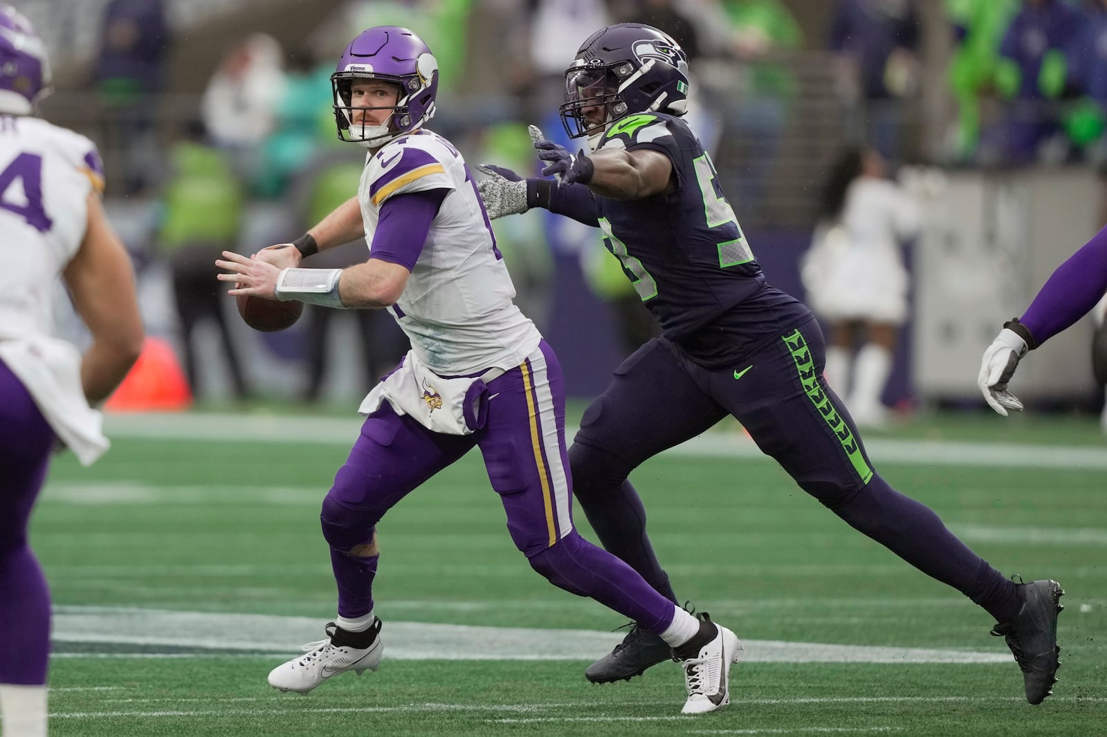 Minnesota Vikings quarterback Sam Darnold (14) is sacked by Seattle Seahawks linebacker Boye Mafe (53) during the first half of an NFL football game, Sunday, Dec. 22, 2024, in Seattle. (AP Photo/Stephen Brashear)