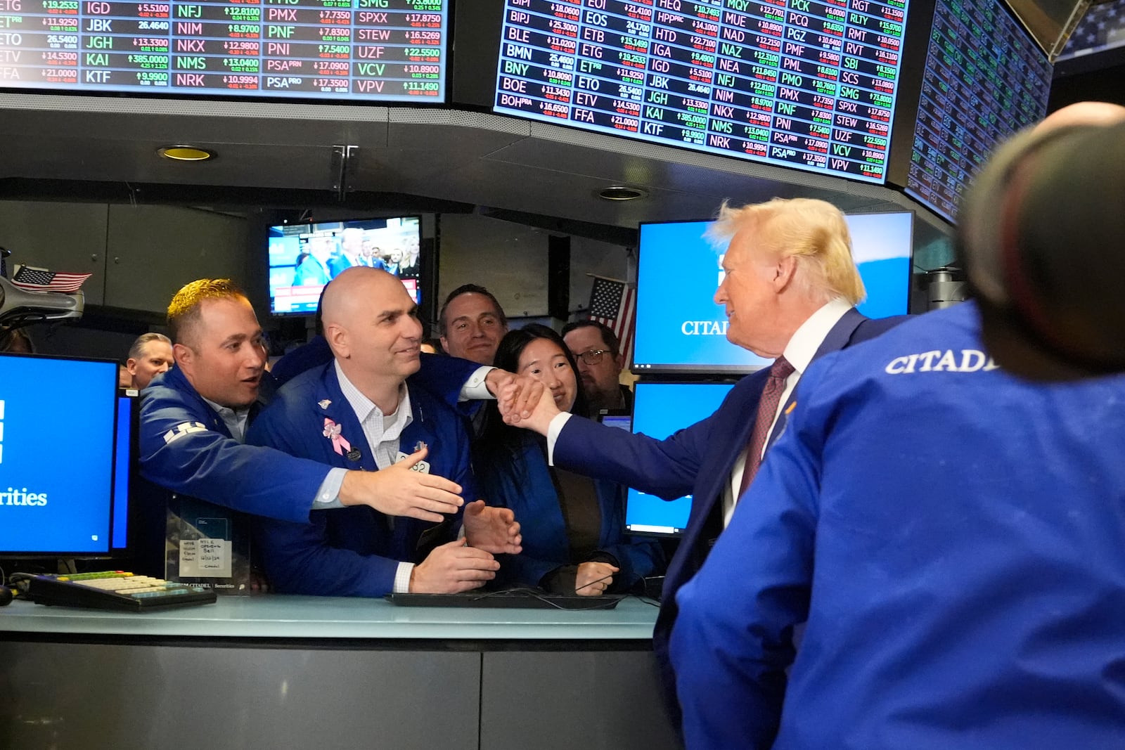 President-elect Donald Trump is greeted by traders, as he walks the floor of the New York Stock Exchange, Thursday, Dec. 12, 2024, in New York. (AP Photo/Alex Brandon)