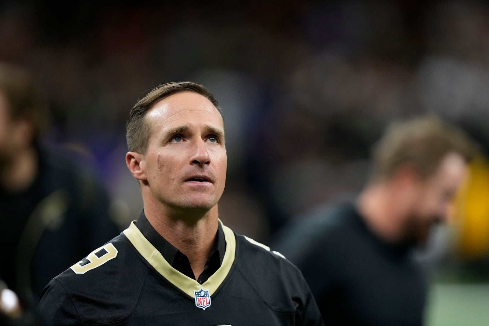 Former New Orleans Saints quarterback Drew Brews walks on the field before an NFL football game between the Saints and the Denver Broncos, Thursday, Oct. 17, 2024, in New Orleans. (AP Photo/Gerald Herbert)