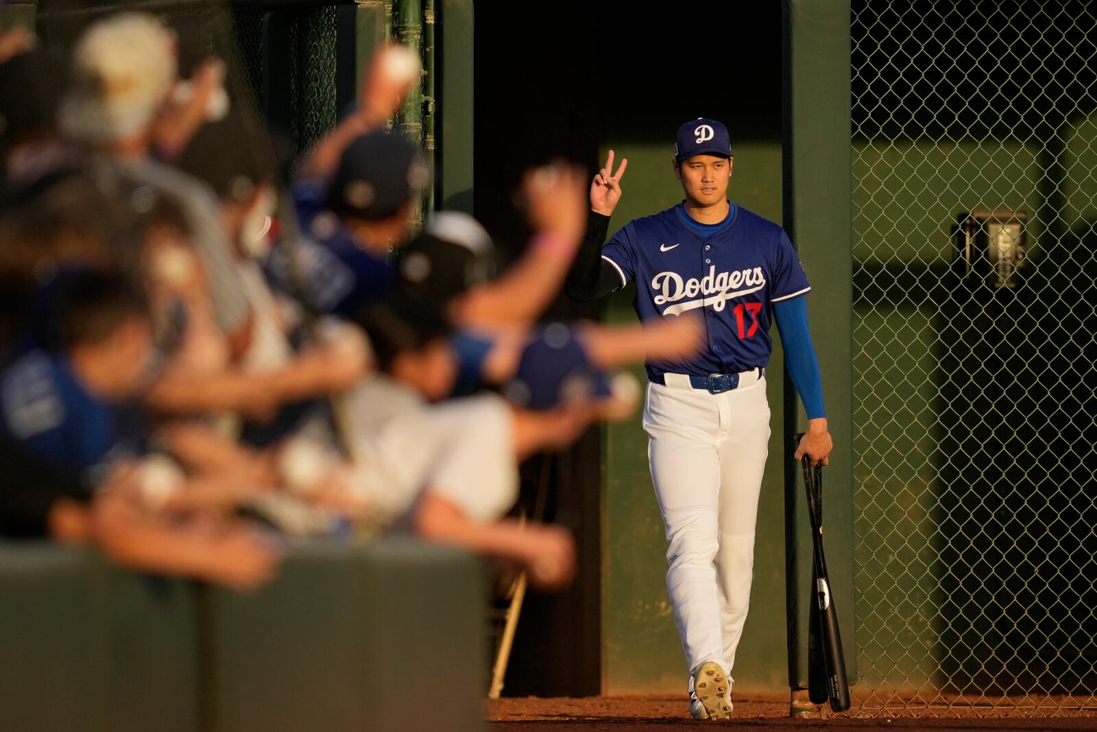 Los Angeles Dodgers designated hitter Shohei Ohtani enters the field before a spring training baseball game against the Los Angeles Angels, Friday, Feb. 28, 2025, in Phoenix. (AP Photo/Ashley Landis)