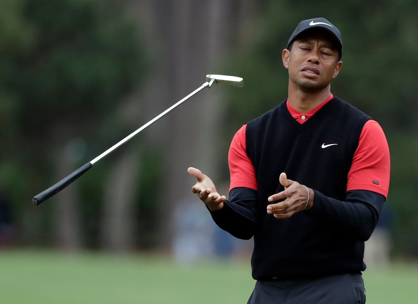 FILE - Tiger Woods flips his club after his shot to the 10th green during the final round of The Players Championship golf tournament Sunday, March 17, 2019, in Ponte Vedra Beach, Fla. (AP Photo/Lynne Sladky, File)