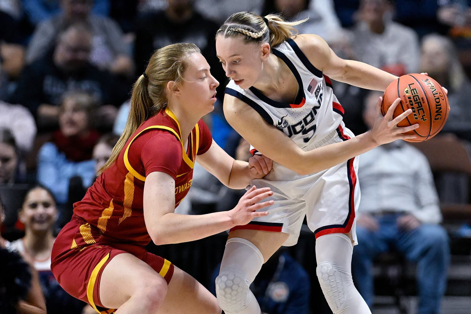 Iowa State guard Emily Ryan, left, guards UConn guard Paige Bueckers in the second half of an NCAA college basketball game, Tuesday, Dec. 17, 2024, in Uncasville, Conn. (AP Photo/Jessica Hill)