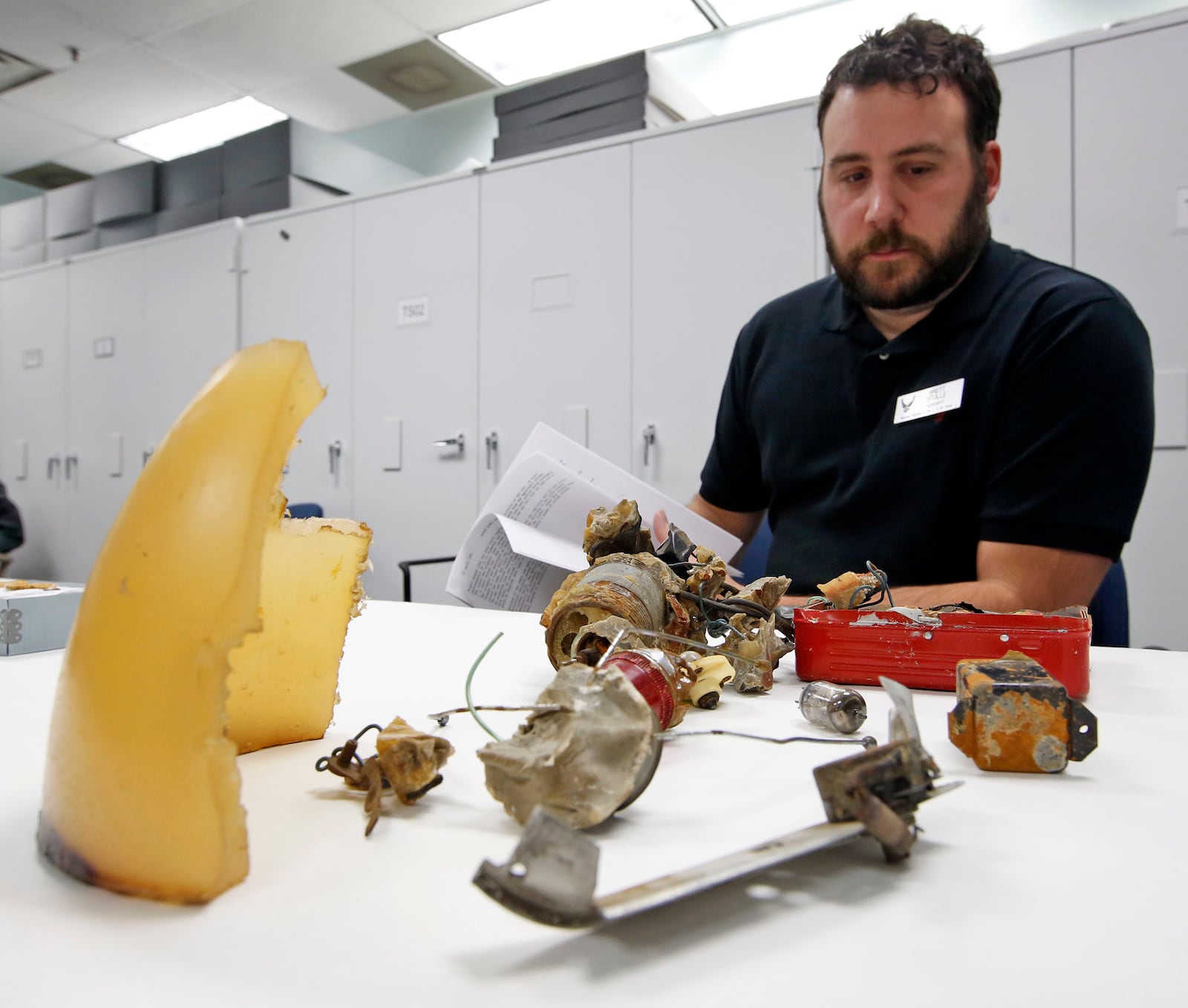 National Museum of the United States Air Force curator Brett Stolle examines the remnants of a UFO that was identified by the U.S. Air Force Project Blue Book program as part of a hoax. 2017.  TY GREENLEES / STAFF