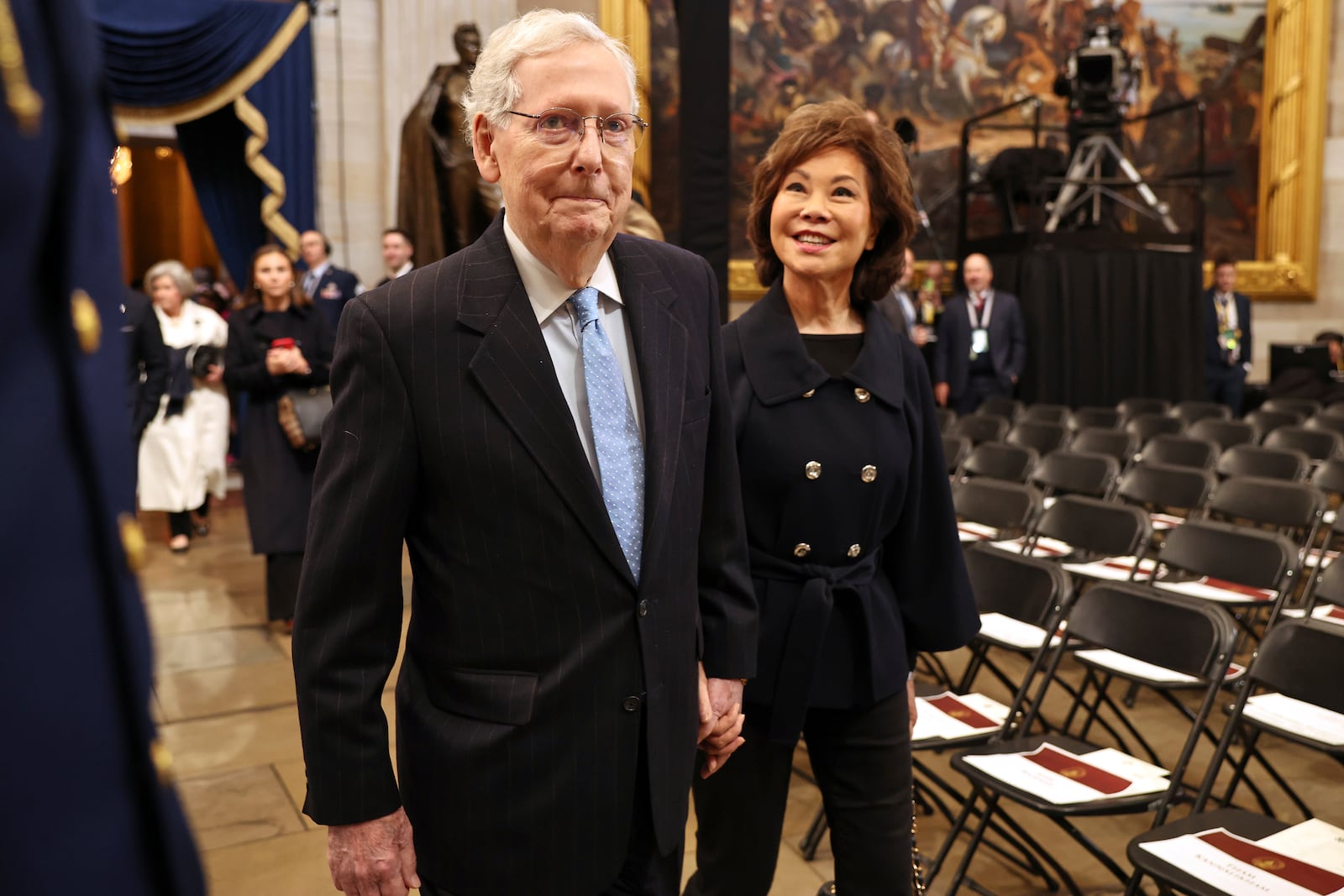 Sen. Mitch McConnell, R-Ky., left, arrives with his wife, former U.S. Secretary of Transportation Elaine Chao, before the 60th Presidential Inauguration in the Rotunda of the U.S. Capitol in Washington, Monday, Jan. 20, 2025. (Chip Somodevilla/Pool Photo via AP)