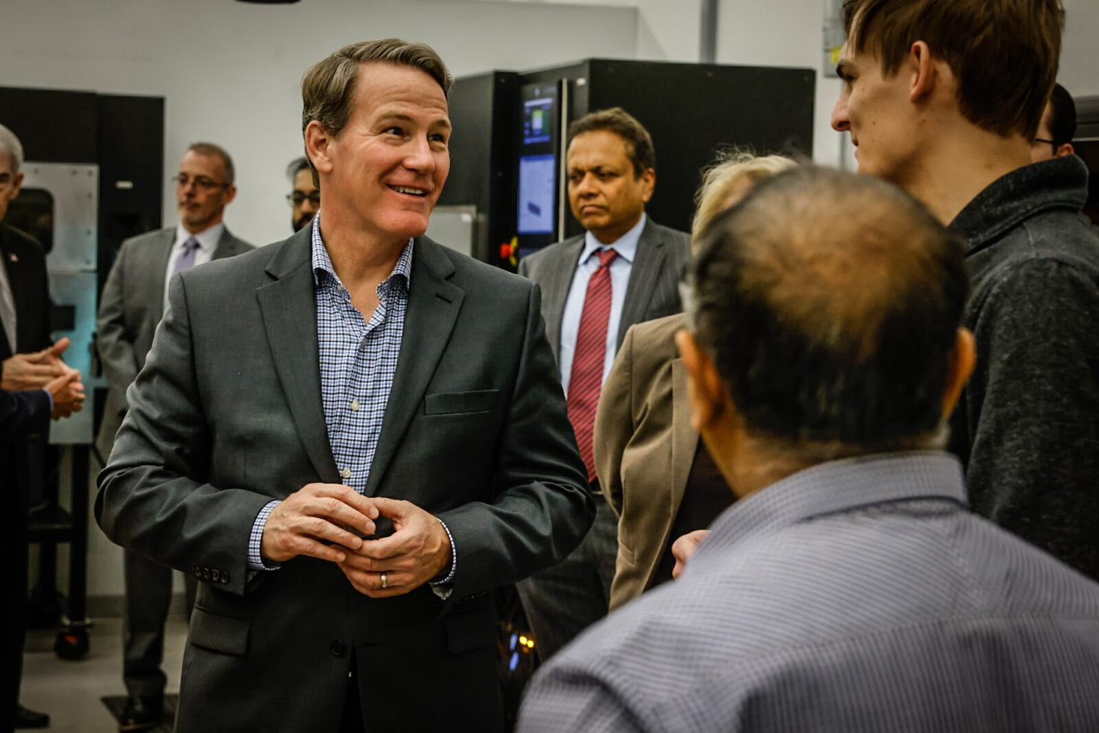 Lt. Gov. Joh Husted, left, talks with Wright State University senior, Alexander Adams, right, who studies mechanical engineering. The university purchased the equipment using the RAPIDS grants program to help more schools produce a talented workforce. JIM NOELKER/STAFF