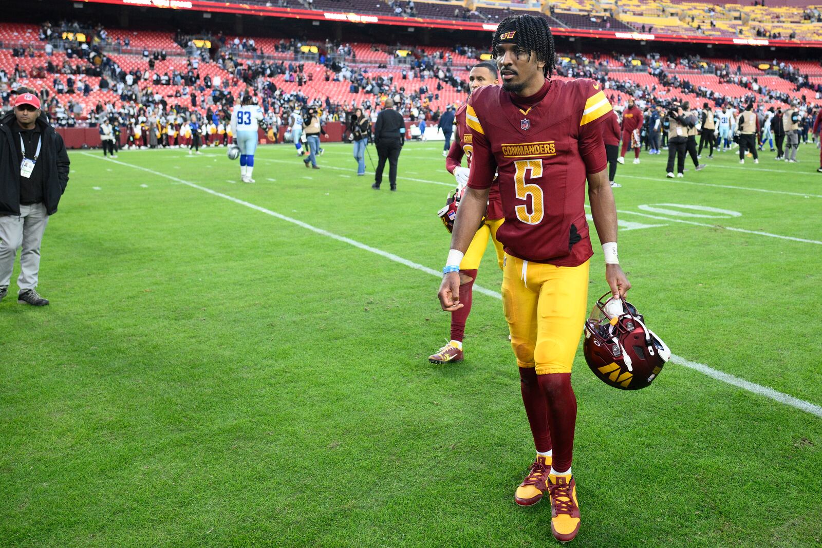 Washington Commanders quarterback Jayden Daniels (5) walks across the field after the 34-26 loss to the Dallas Cowboys of an NFL football game, Sunday, Nov. 24, 2024, in Landover, Md. (AP Photo/Nick Wass)