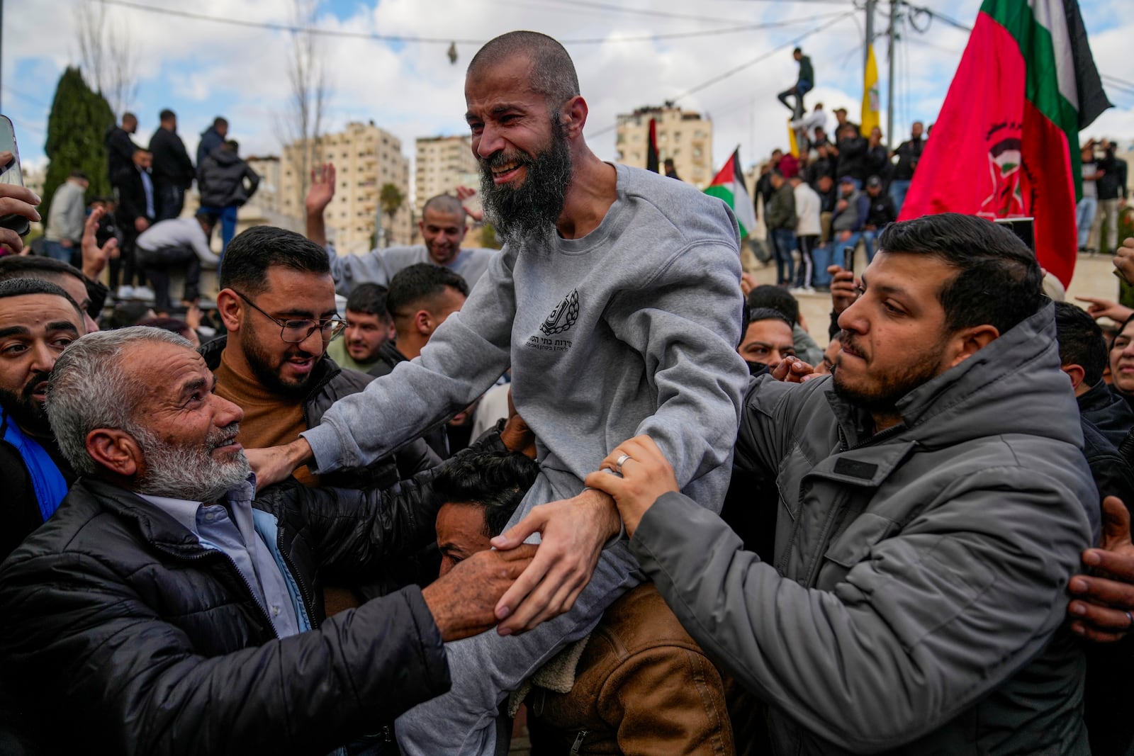 Palestinian prisoners are greeted by a crowd after being released from Israeli prison following a ceasefire agreement with Israel, in the West Bank city of Ramallah, Saturday, Jan. 25, 2025. (AP Photo/Nasser Nasser)