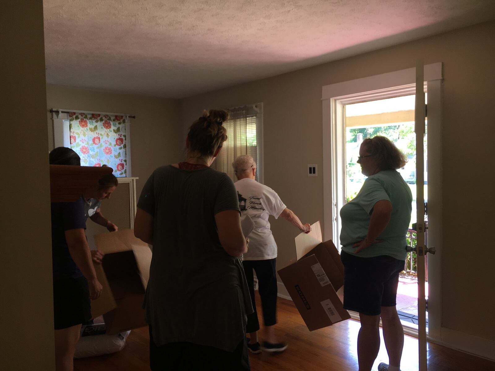 Volunteers for the Shiloh Tornado Assistance for Families program help move donated items into the home. BONNIE MEIBERS/STAFF