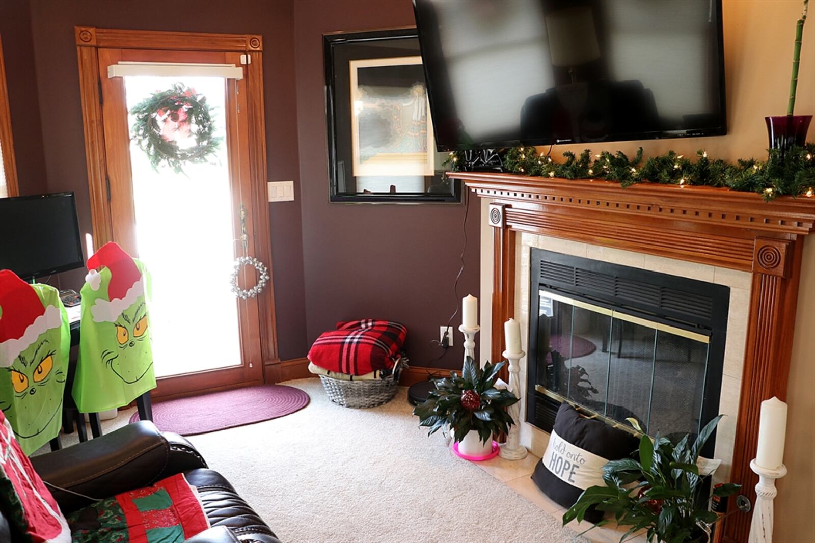 A gas fireplace has a dentil wood mantel with ceramic-tile hearth. 