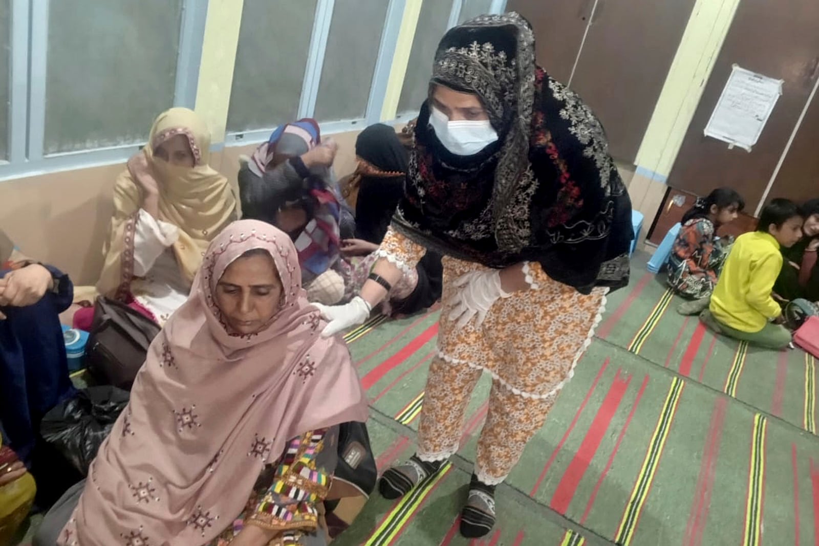 Passengers rescued by security forces from a passenger train attacked by insurgents, rest upon their arrival at the Mach railway station near Quetta, Pakistan, Tuesday, March 11, 2025. (AP Photo)