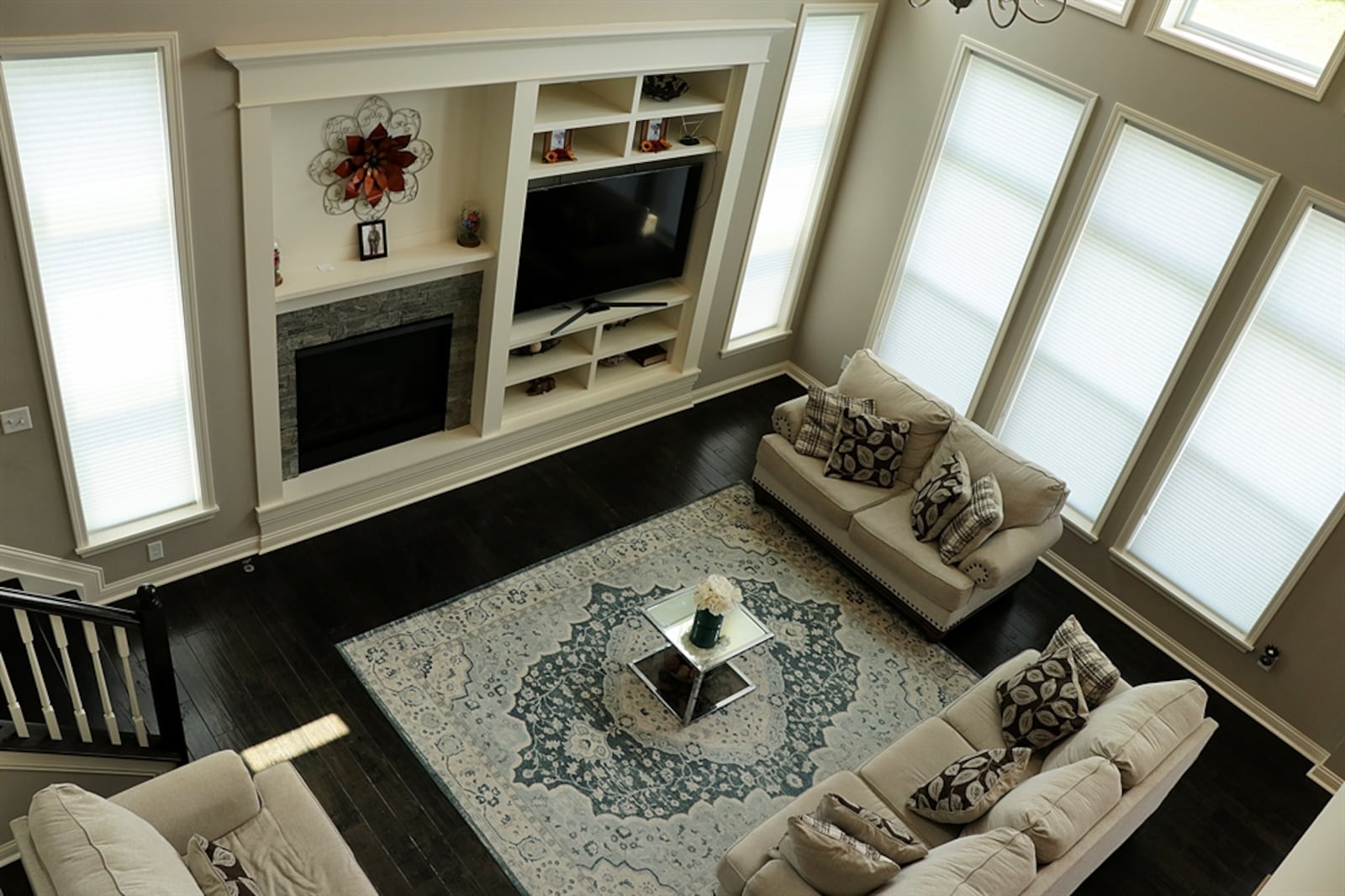 The dining room has a tray ceiling and access to a bar or butler’s pantry area where there is cabinetry with granite countertops, glass and bottle racks and a wine cooler. A sitting room is tucked behind the kitchen and dining area, creating a cozy game or media room. Kathy Tyler/CONTRIBUTED