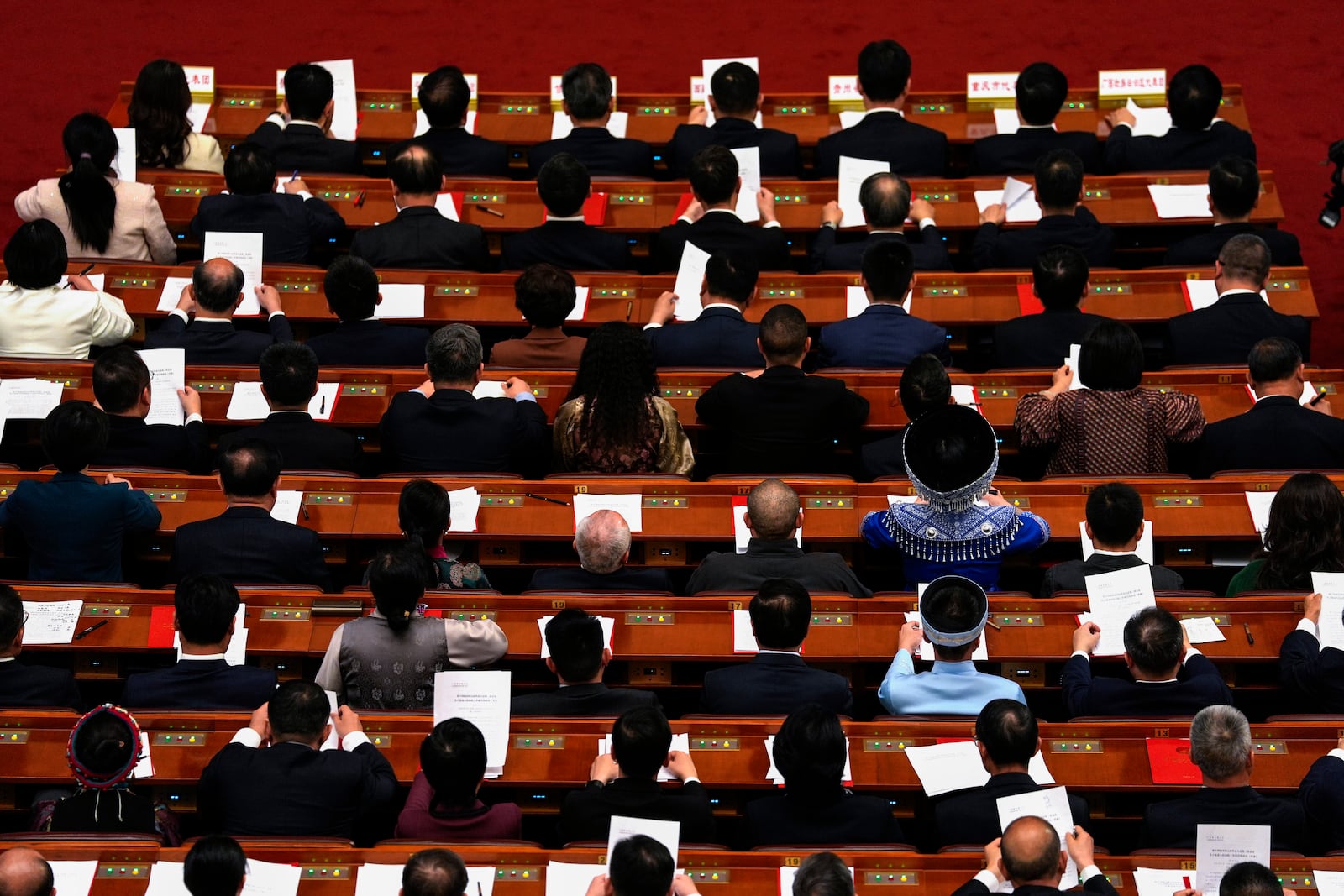 Delegates attend the closing ceremony of the National People's Congress held at the Great Hall of the People in Beijing, Tuesday, March 11, 2025. (AP Photo/Ng Han Guan)