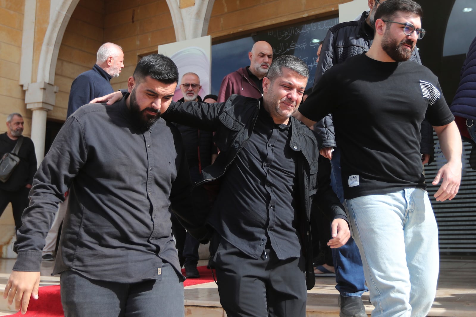 The brother of Hezbollah's chief spokesman Mohammed Afif, center, killed in an Israeli airstrike in Beirut on Sunday, mourns during his funeral in the southern port city of Sidon, Lebanon, Monday, Nov. 18, 2024. (AP Photo/Mohammed Zaatari)