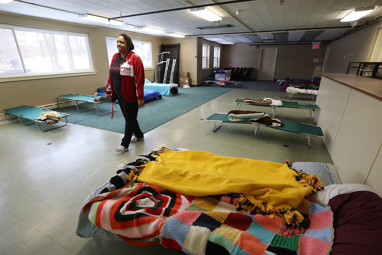 Larina Bias, program manager at Interfaith Hospitality Network, walks through overflow sleeping room at the Network’s Family Shelter Friday. With record-breaking cold temperatures, Springfield’s Interfaith Hospitality Center has seen an influx of people seeking shelter. Bill Lackey/Staff