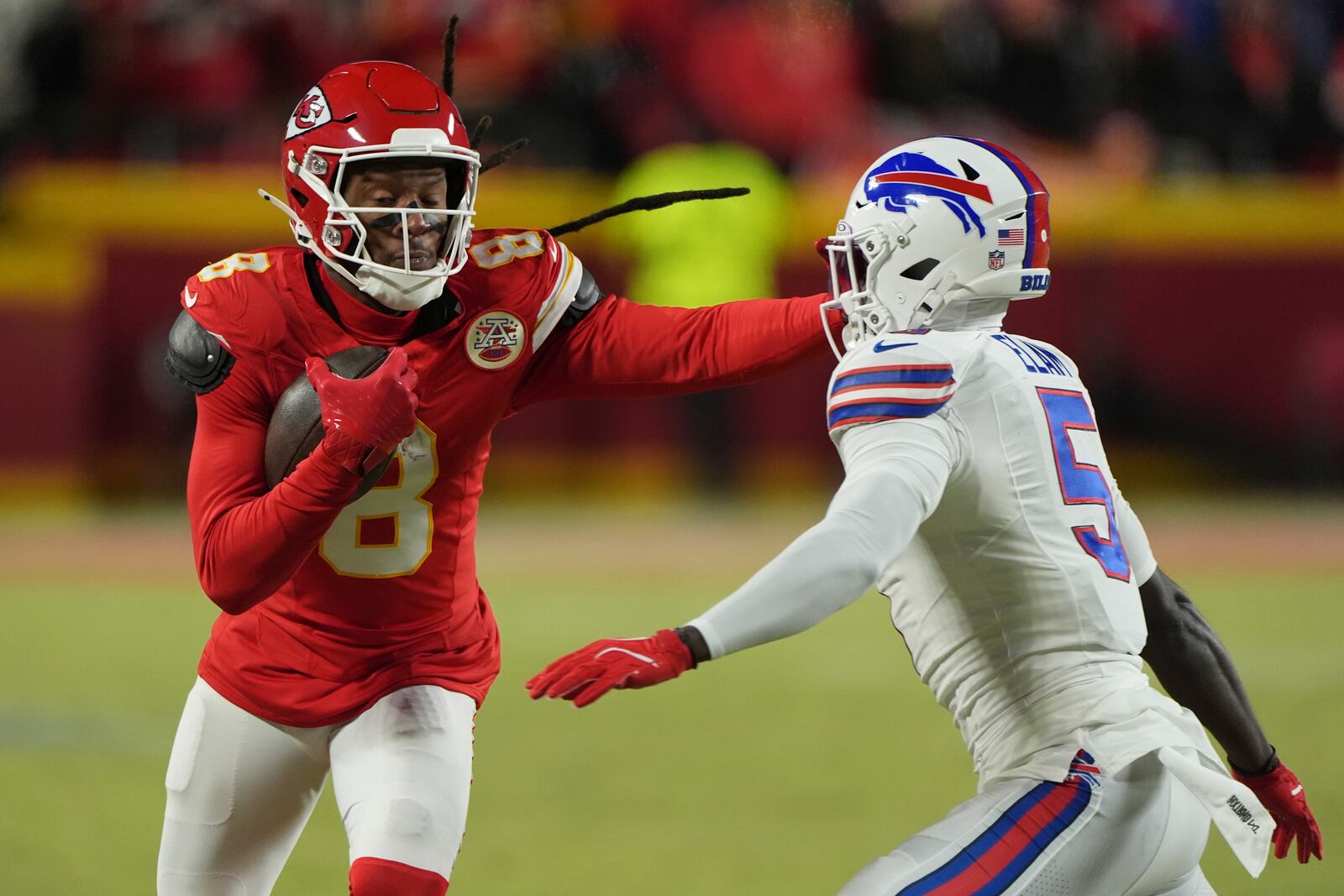 Kansas City Chiefs wide receiver DeAndre Hopkins (8) runs with the ball past Buffalo Bills cornerback Kaiir Elam (5) during the first half of the AFC Championship NFL football game, Sunday, Jan. 26, 2025, in Kansas City, Mo. (AP Photo/Charlie Riedel)