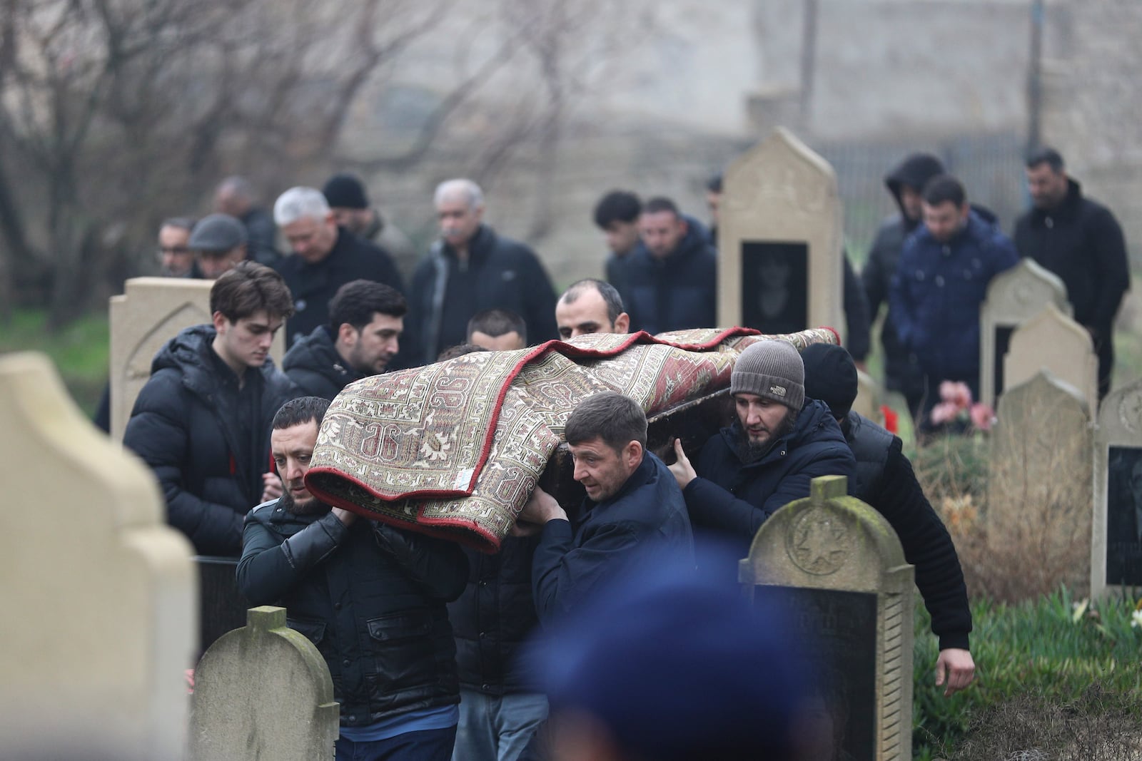 People attend a funeral of Mahammadali Eganov who died in the Azerbaijan Airlines Embraer 190 crash near the Kazakhstan's airport of Aktau at the age of 13, in Baku, Azerbaijan, Saturday, Dec. 28, 2024. (AP Photo)