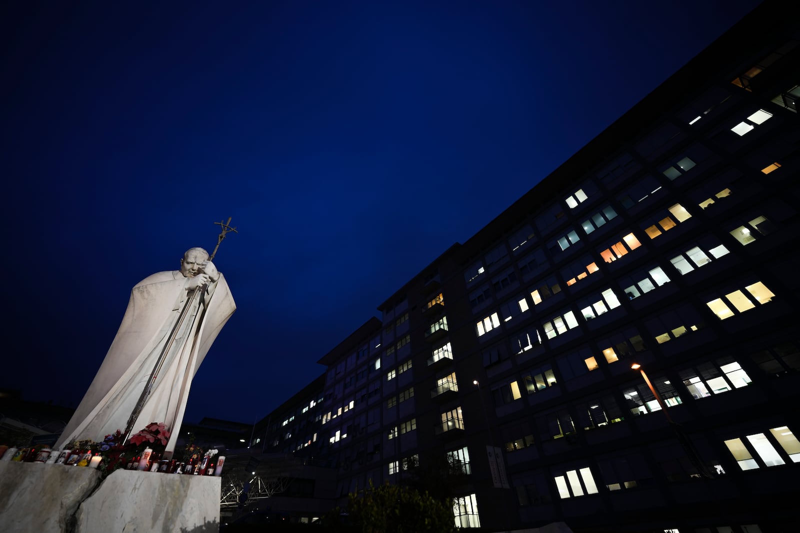 A statue of Pope John Paul II is seen in front of the Agostino Gemelli Polyclinic, Rome, Wednesday, Feb. 19, 2025, where the Pontiff is hospitalized since Friday, Feb. 14. (AP Photo/Andrew Medichini)