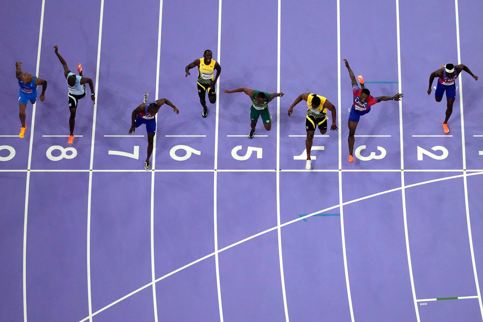 FILE - Noah Lyles, of the United States, in lane seven, wins the men's 100-meter final at the 2024 Summer Olympics, Sunday, Aug. 4, 2024, in Saint-Denis, France. (AP Photo/David J. Phillip, File)