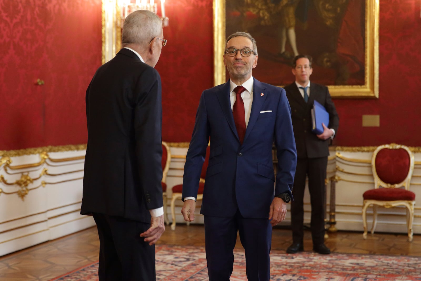 Austrian President Alexander Van der Bellen, left, welcomes Austrian Freedom Party leader Herbert Kickl, center, in his office in Vienna, Austria, Monday, Jan. 6, 2025. (AP Photo/Heinz-Peter Bader)