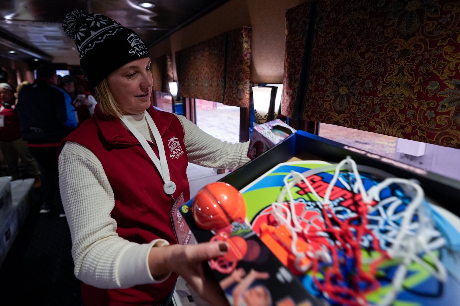 Diana Sorfleet prepares a gift bag during the 82nd run of the CSX Santa Train, Saturday, Nov. 23, 2024, in Dante, Va. (AP Photo/George Walker IV)