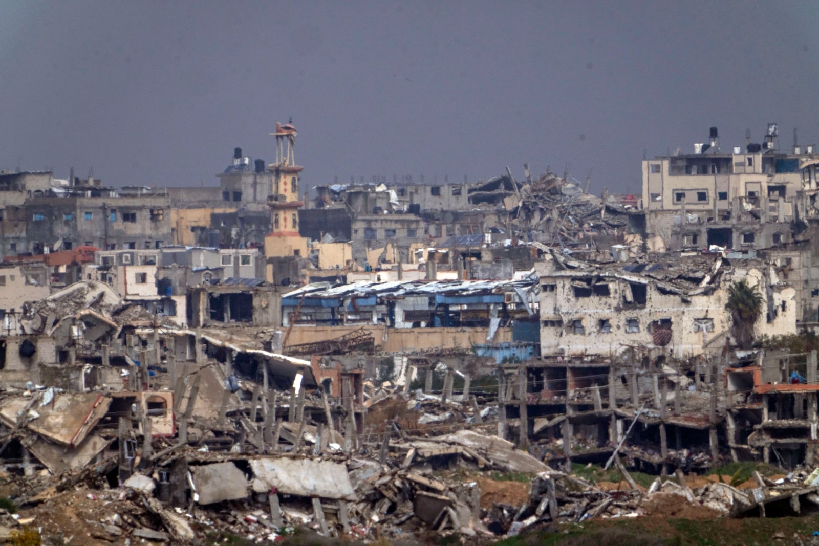 Destroyed buildings by Israeli bombardments inside the northern Gaza Strip as seen from southern Israel, Tuesday, Feb.11, 2025. (AP Photo/Ariel Schalit)