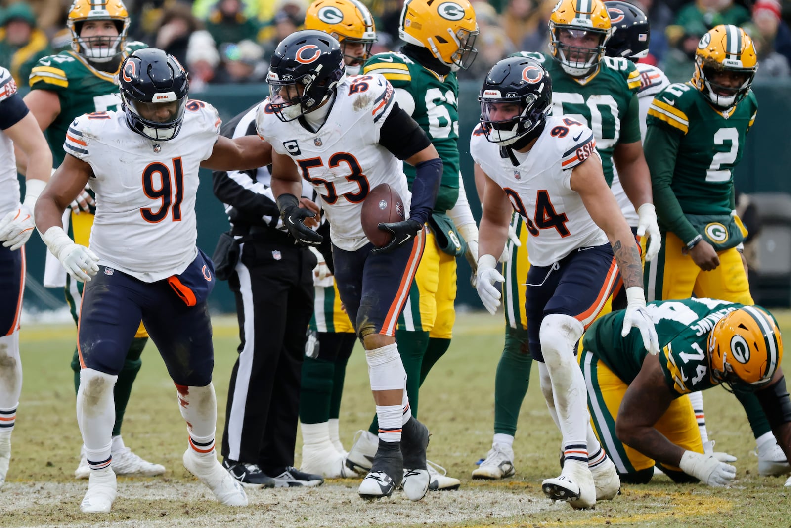 Chicago Bears linebacker T.J. Edwards (53) reacts after recovering a fumble by Green Bay Packers quarterback Malik Willis (2) with defensive tackle Chris Williams (91) and defensive end Austin Booker (94) during the second half of an NFL football game, Sunday, Jan. 5, 2025, in Green Bay, Wis. (AP Photo/Mike Roemer)