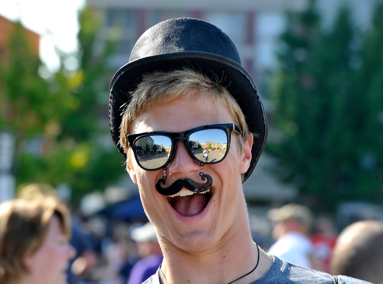 A fan with his Mumford and Sons mustache and hat Friday in Troy. Bill Lackey/Staff