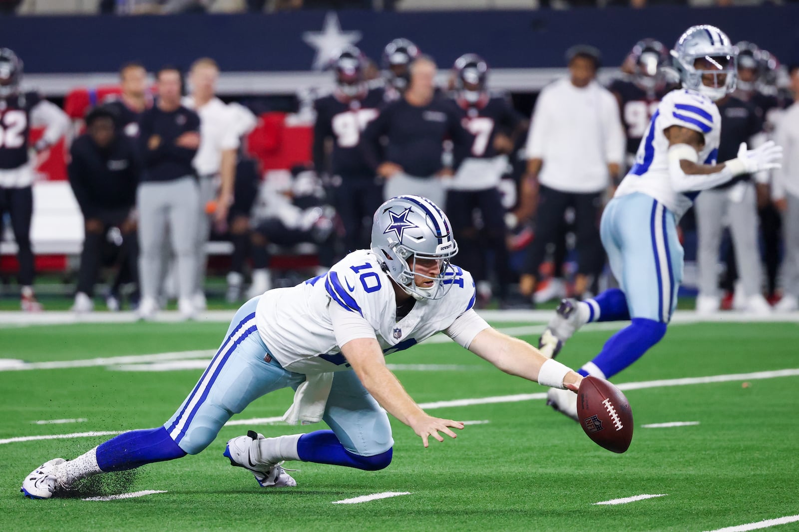 Dallas Cowboys quarterback Cooper Rush fumbles the snap against the Houston Texans during the second half of an NFL football game, Monday, Nov. 18, 2024, in Arlington, Texas. (AP Photo/Gareth Patterson)