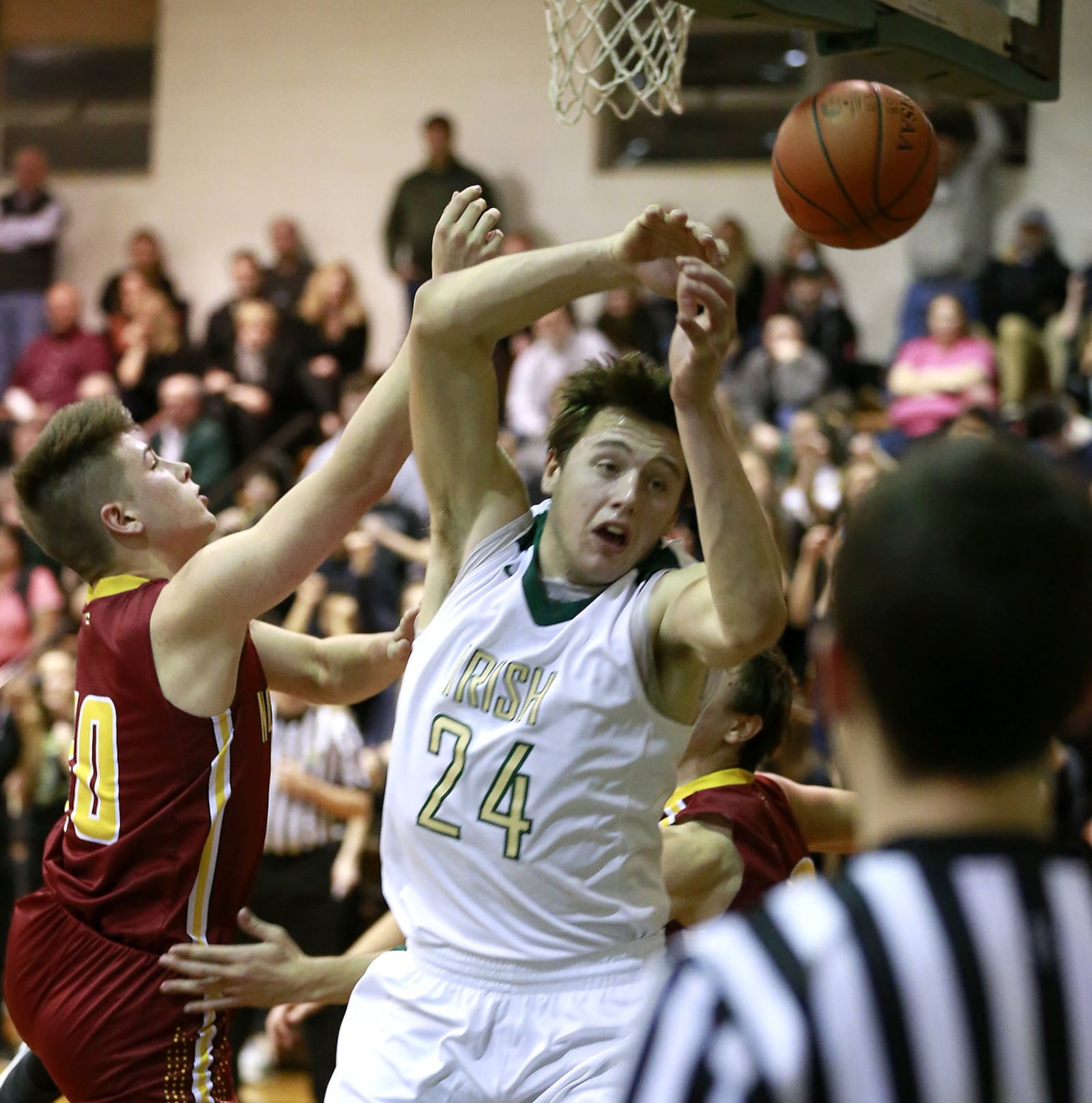 Catholic Central’s Cosmas Catanzaro and Northeastern’s Wesley Roberts battle for a rebound. BILL LACKEY / STAFF