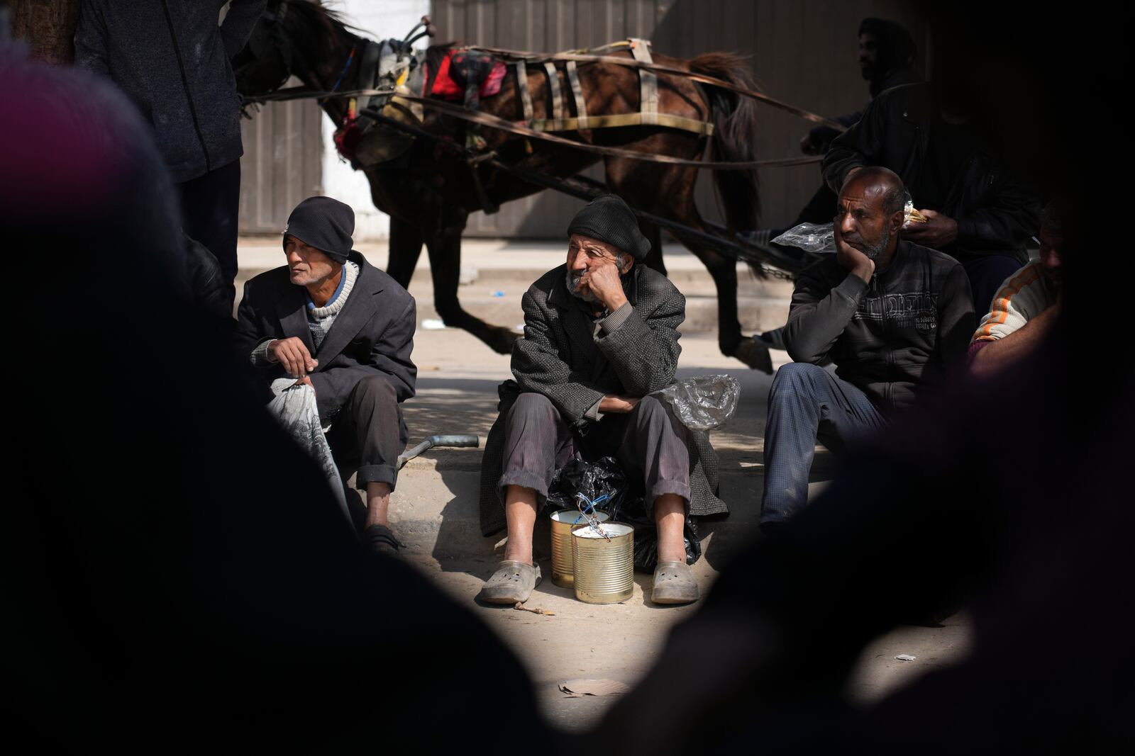 Palestinians queue for food distribution in Deir al-Balah, Gaza Strip, Friday, Feb. 14, 2025. (AP Photo/Abdel Kareem Hana)