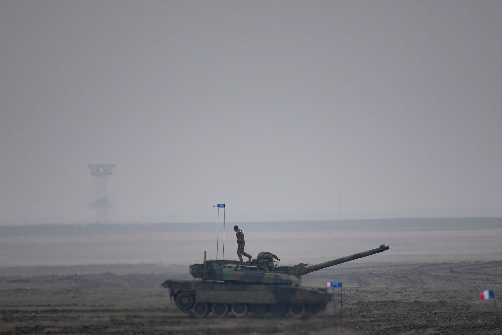 FILE - A French serviceman walks on a Leclerc main battle tank during an exercise at a training range in Smardan, eastern Romania, Wednesday, Jan. 25, 2023. (AP Photo/Vadim Ghirda, File)