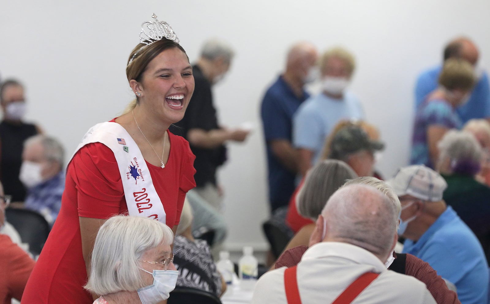 Rebekah Hardacre, the 2022 Clark County Fair Queen, laughes as she talks to couples at the Golden Wedding Party Tuesday, July 26, 2022. BILL LACKEY/STAFF