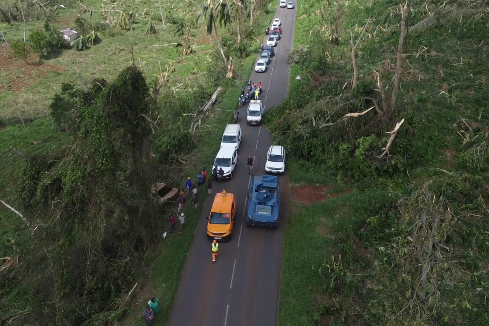 This photo provided on Monday Dec.16, 2024 by the Gendarmerie Nationale, shows fallen trees along a road Sunday, Dec. 15, 2024 in Mayotte as France rushed rescue teams and supplies to its largely poor overseas department in the Indian Ocean that has suffered widespread destruction. (Gendarmerie Nationale via AP)