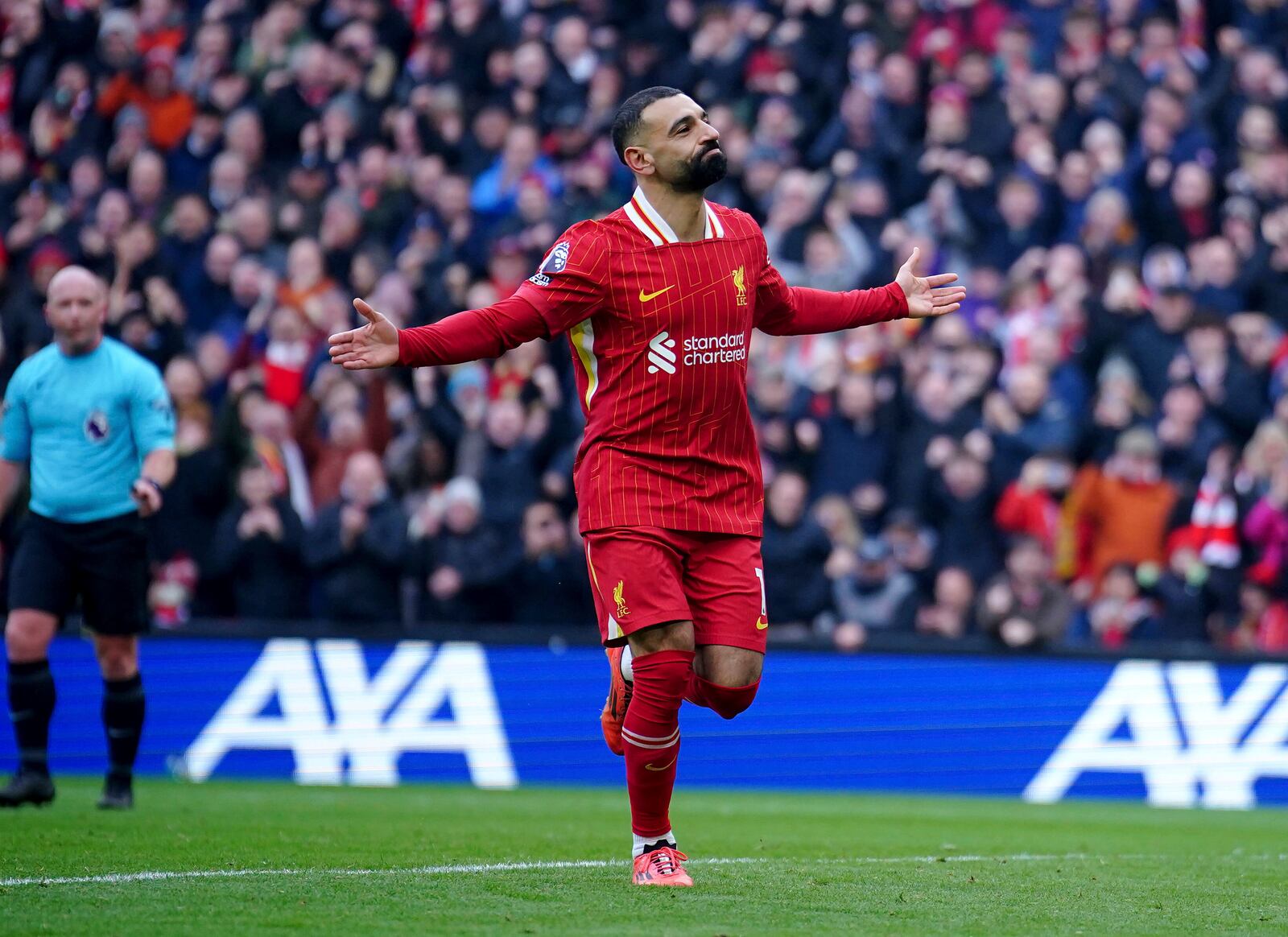 Liverpool's Mohamed Salah celebrates after scoring his side' second goal during the English Premier League soccer match between Liverpool and Wolverhampton Wanderers at Anfield Stadium in Liverpool, Sunday, Feb. 16, 2025. (Peter Byrne/PA via AP)