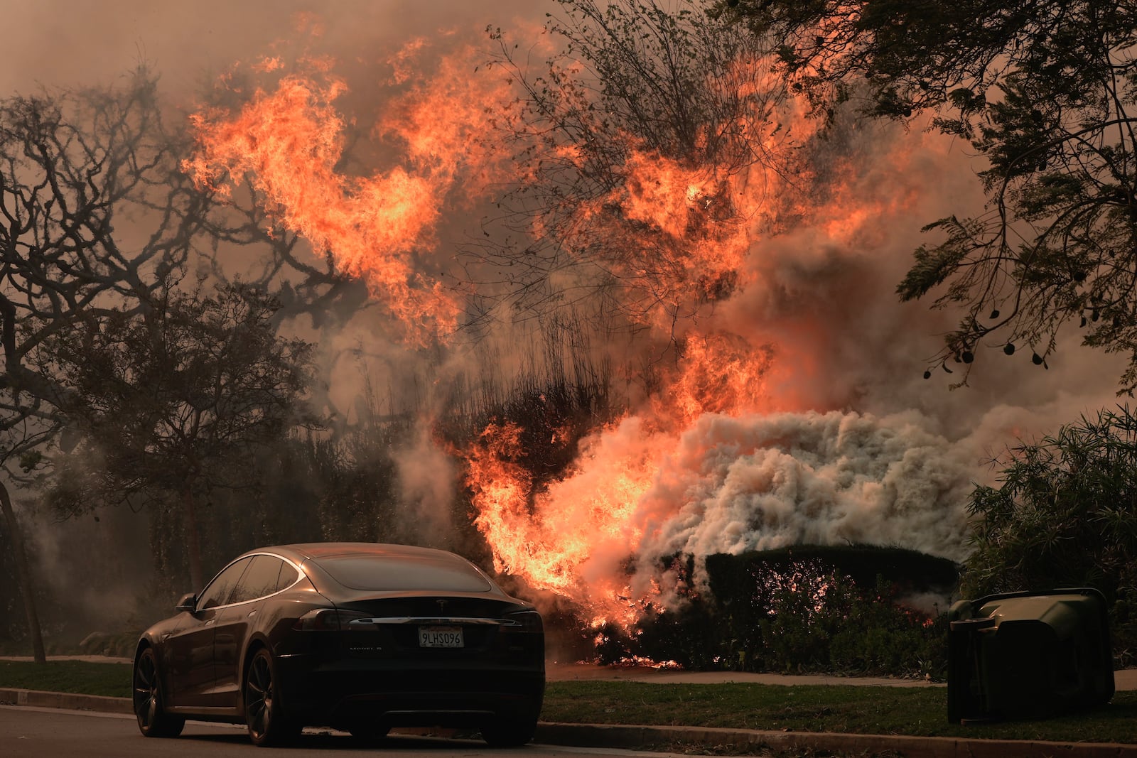 The Palisades Fire ravages a neighborhood amid high winds in the Pacific Palisades neighborhood of Los Angeles, Wednesday, Jan. 8, 2025. (AP Photo/Damian Dovarganes)