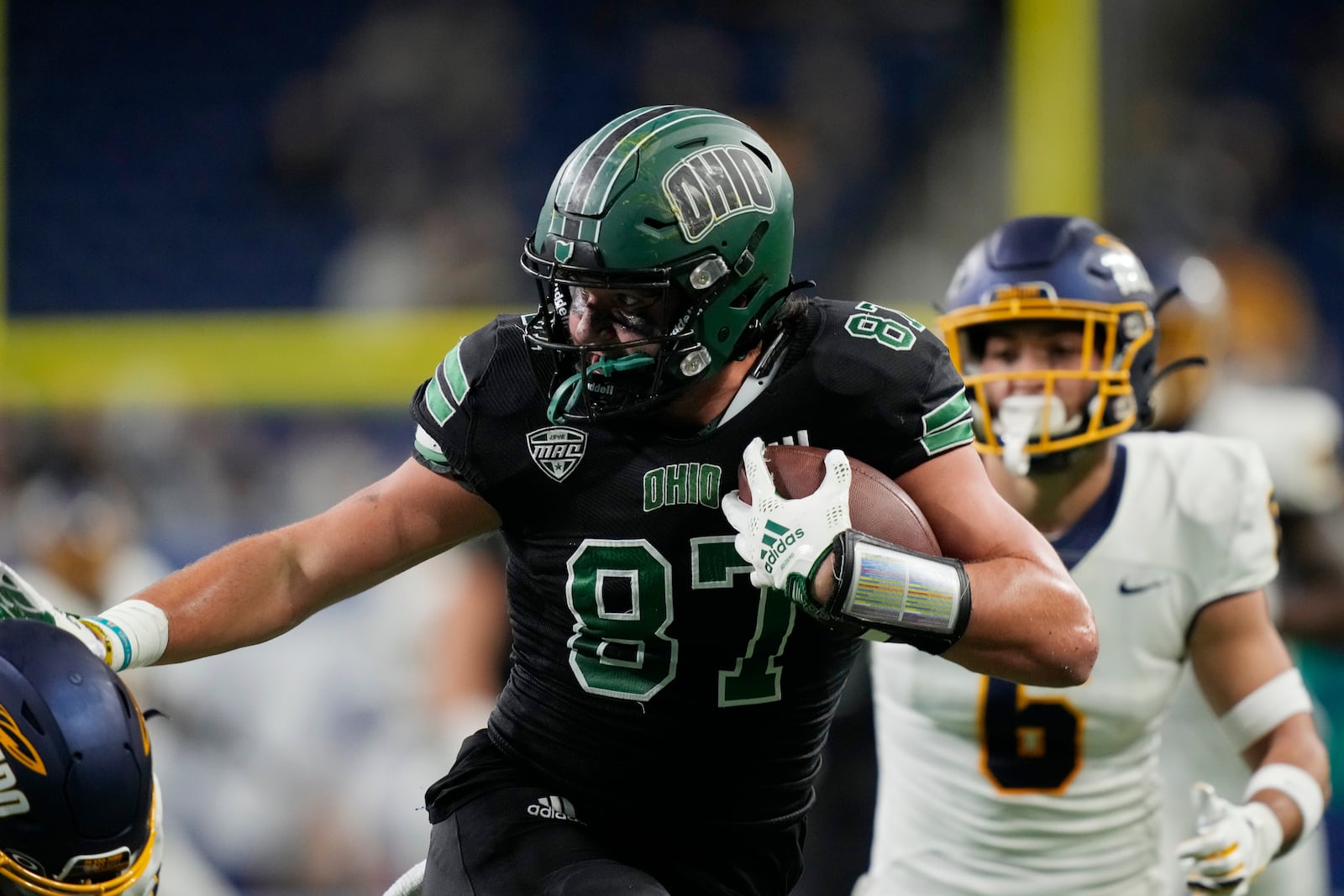 Ohio tight end Will Kacmarek (87) pushes away a defender during the first half of the Mid-American Conference championship NCAA college football game against Toledo, Saturday, Dec. 3, 2022, in Detroit. (AP Photo/Carlos Osorio)