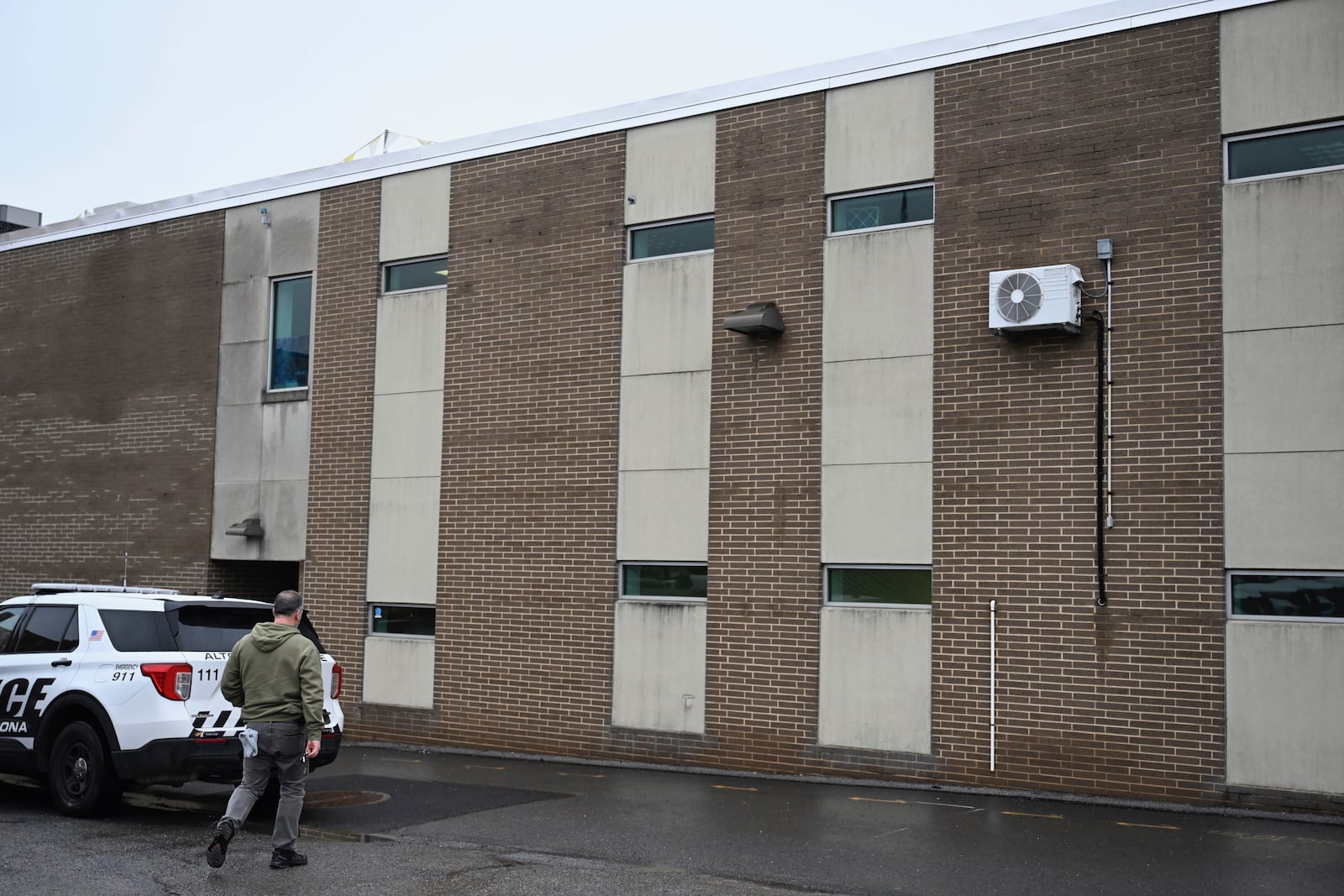 A law enforcement officer walks into the Altoona Police Department, where suspect in the UnitedHealthcare CEO shooting, 26-year old Luigi Mangione is being held Monday, Dec. 9, 2024. (Benjamin B. Braun/Pittsburgh Post-Gazette via AP)