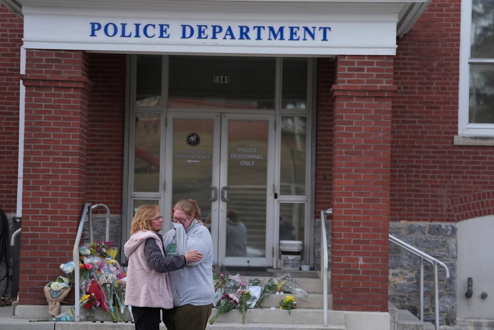 Leah Fauth gets emotionalafter leaving flowers in front of the West York Police Department after a police officer was killed responding to a shooting at UPMC Memorial Hospital in York, Pa. on Saturday, Feb. 22, 2025. (AP Photo/Matt Rourke)