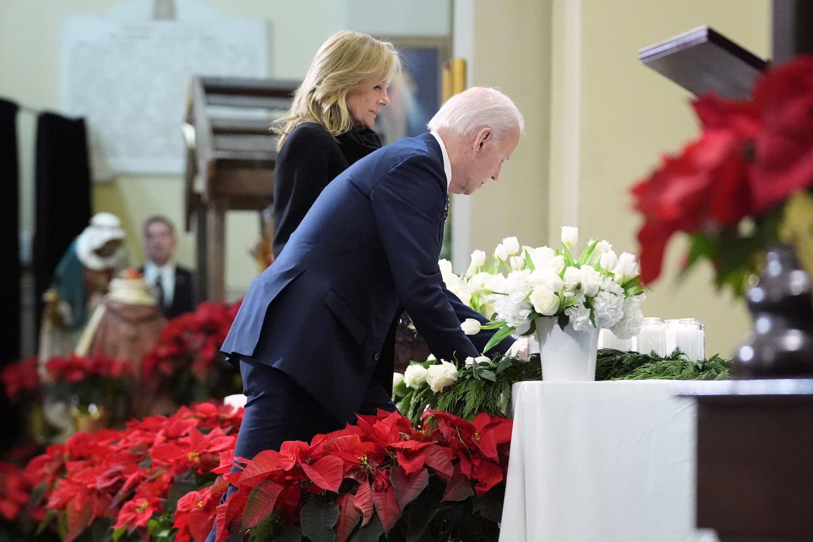 President Joe Biden and first lady Jill Biden place a candle at the alter as they participate in an interfaith prayer service for the victims of the deadly New Years truck attack, at St. Louis Cathedral in New Orleans, Monday, Jan. 6, 2025. (AP Photo/Stephanie Scarbrough)