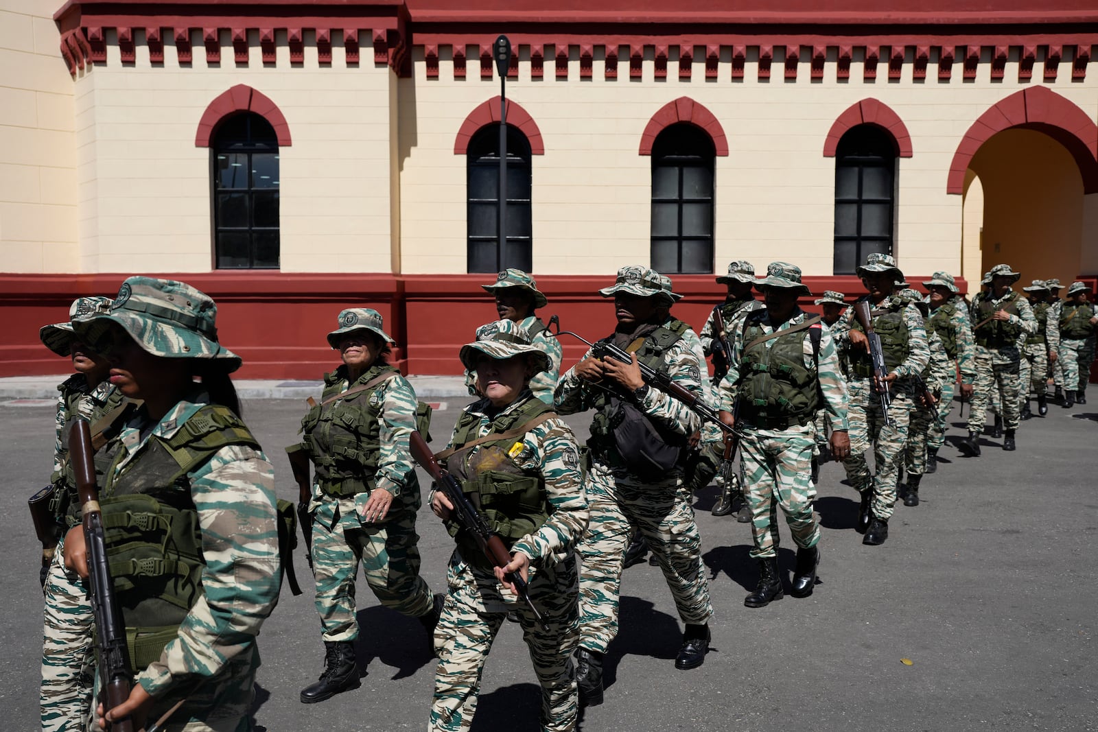 Bolivarian Militia members leave the 4F Military Museum for a gathering of security forces at Miraflores presidential palace in Caracas, Venezuela, Tuesday, Jan. 7, 2025, ahead of the presidential inauguration. (AP Photo/Matias Delacroix)