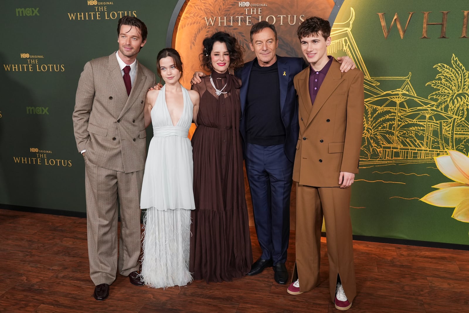 Patrick Schwarzenegger, from left, Sarah Catherine Hook, Parker, Posey, Jason Isaacs, and Sam Nivola arrive at the season three premiere of "The White Lotus" on Monday, Feb. 10, 2025, at Paramount Theater in Los Angeles. (AP Photo/Chris Pizzello)